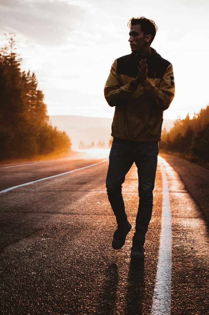 man-in-brown-jacket-and-black-pants-standing-on-road-during-daytime-67mr0jjpmtq