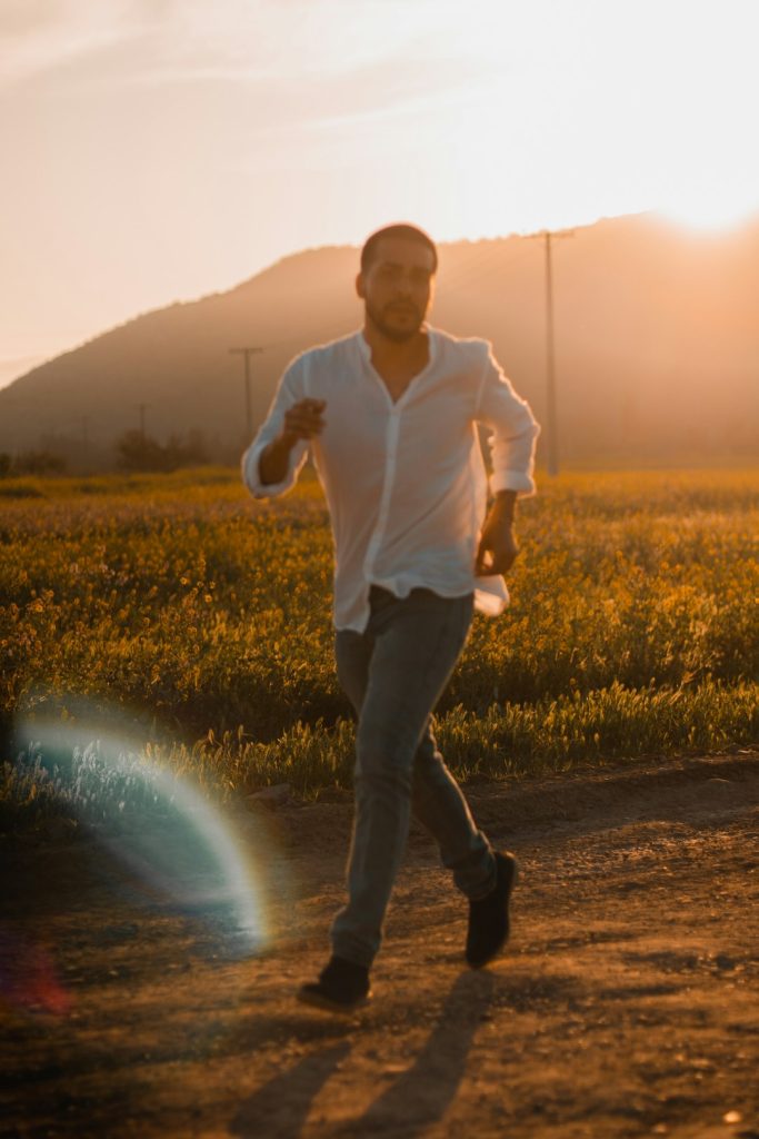 man-in-white-dress-shirt-and-black-pants-standing-on-dirt-road-during-daytime-hgv2nzssypk